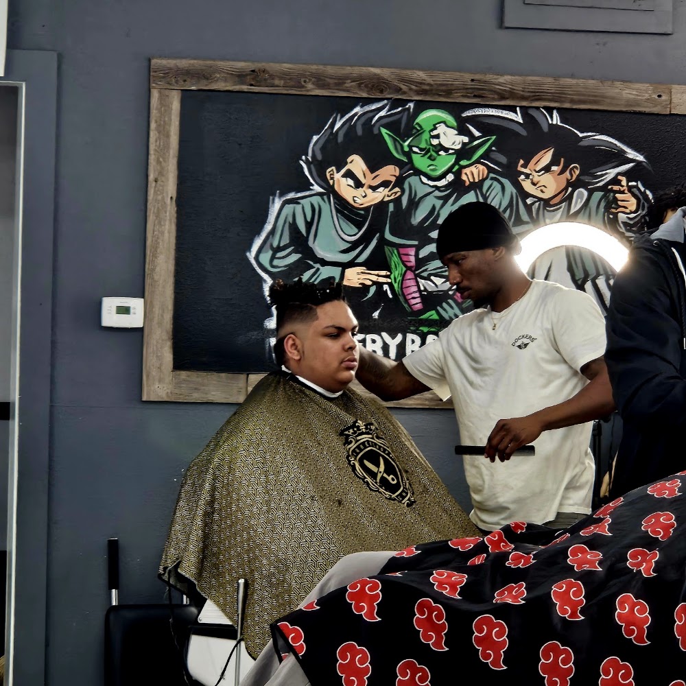Barber cutting a client's hair in the shop